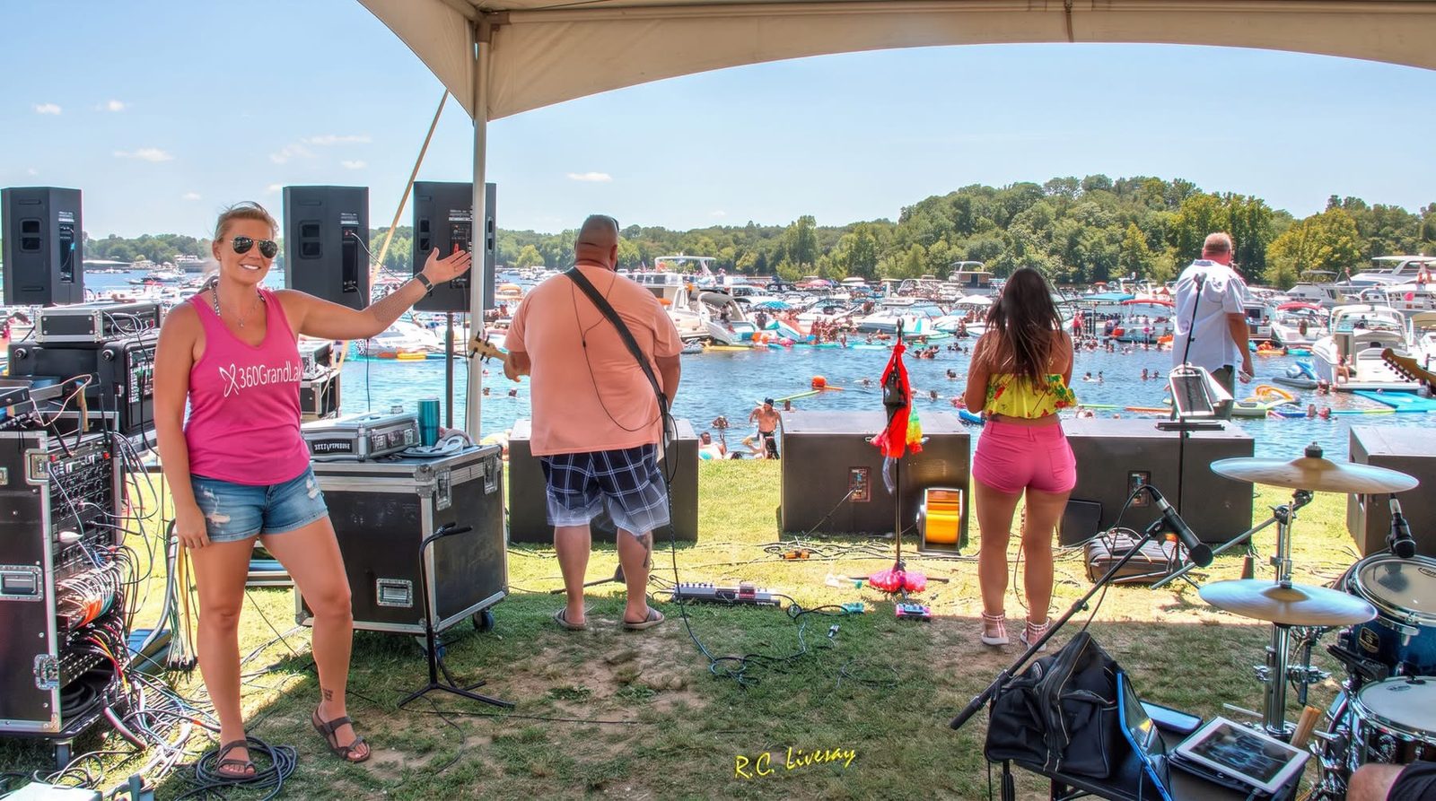 360GrandLake staff on stage at a Grand Lake waterfront live music event with boats rafted together in the cove